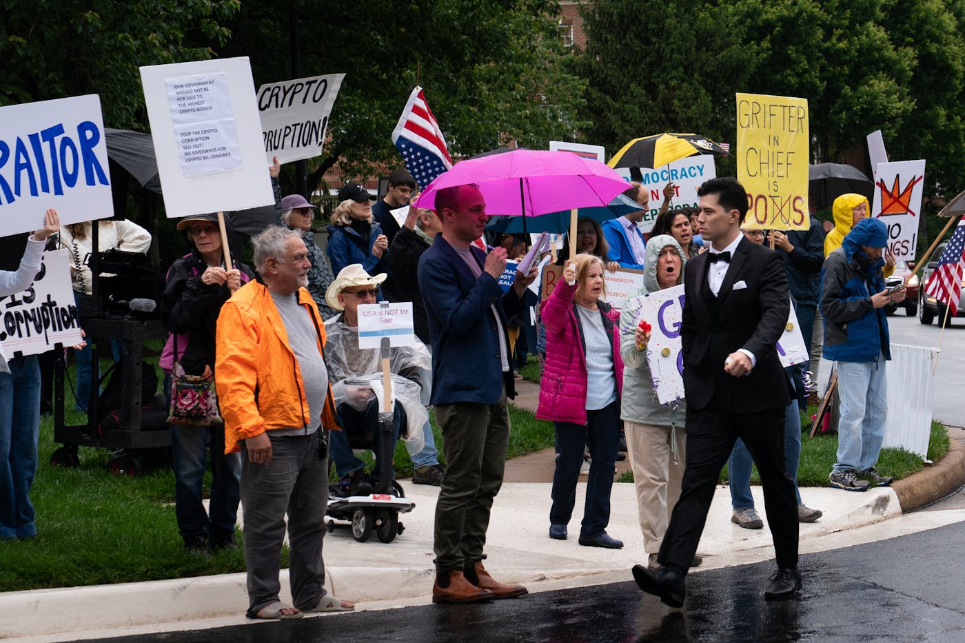 A photo of a guest at Trump’s May 22 memecoin donor dinner in suburban Virginia walking past protesters.