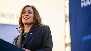 Kamala Harris smiles while at a lectern