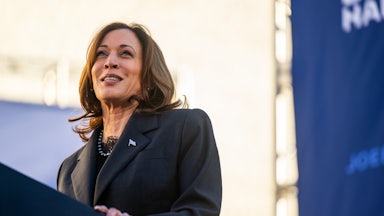 Kamala Harris smiles while at a lectern