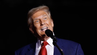 Donald Trump makes a weird face while speaking at a mic