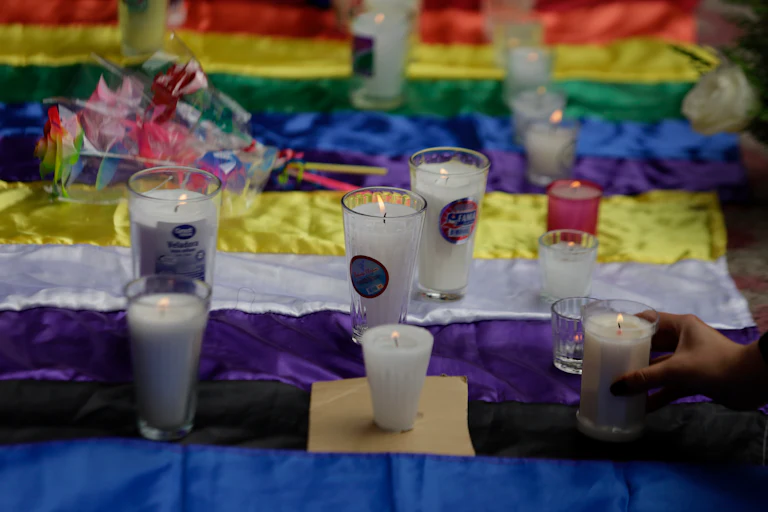 Candles are set on top of the nonbinary and pride flags