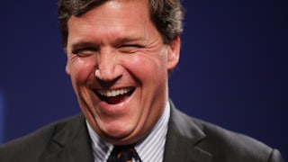 Fox News host Tucker Carlson laughing during happier times (for him). 