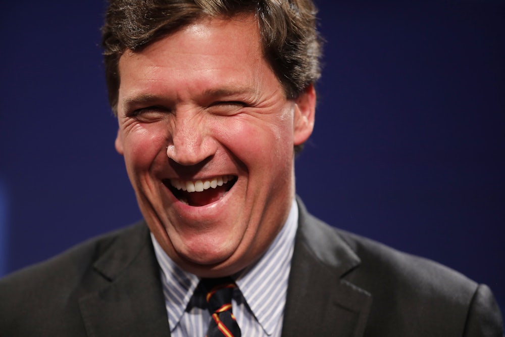 Fox News host Tucker Carlson laughing during happier times (for him).