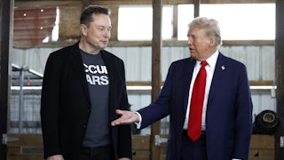 BUTLER, PENNSYLVANIA - OCTOBER 05: Republican presidential nominee, former President Donald Trump offers his hand to Elon Musk back stage during a campaign rally in Butler, Pennsylvania.