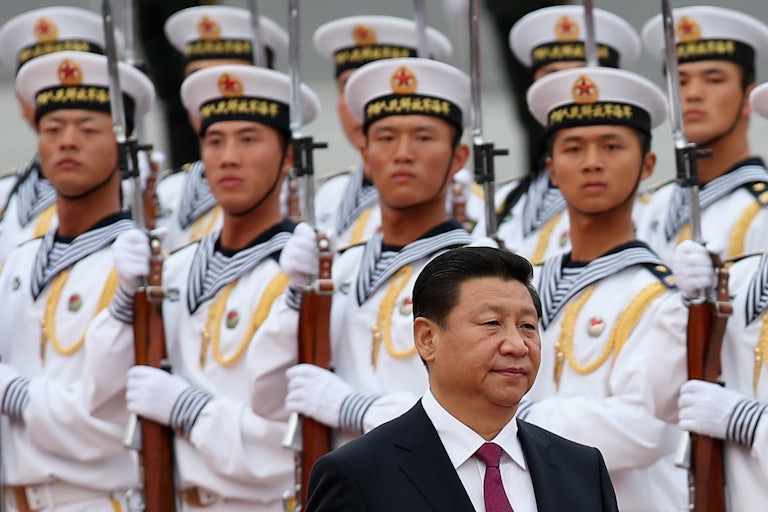 Chinese navy soldiers watch President Xi Jinping