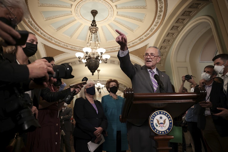 Senate Majority Leader Charles Schumer points as he speaks to reporters at the U.S. Capitol.