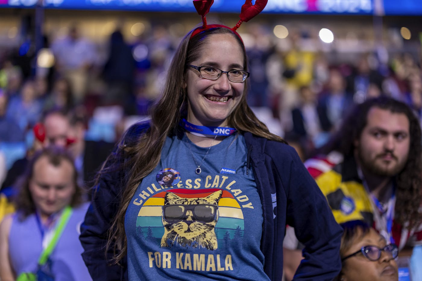 A delegate from Maine shows off her "Childless Cat Lady for Kamala" t-shirt 