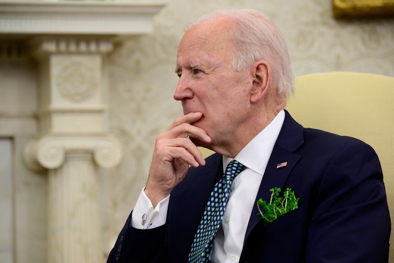 Joe Biden listens during a conference call in the Oval Office.