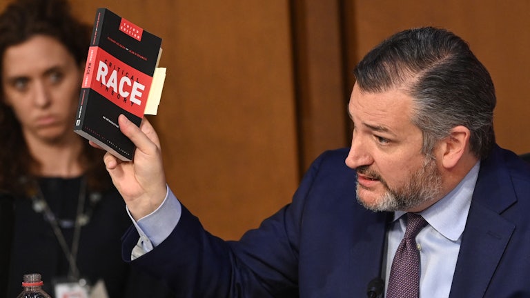 Ted Cruz waves a book about critical race theory during the confirmation hearings of Supreme Court nominee Ketanji Brown Jackson.