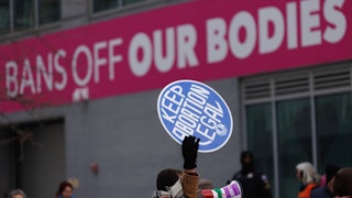 Pro- and anti-abortion protesters stand outside a Planned Parenthood clinic in Washington, D.C.