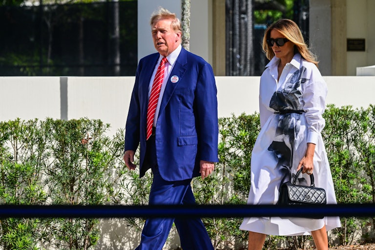 Donald and Melania Trump walk next to each other