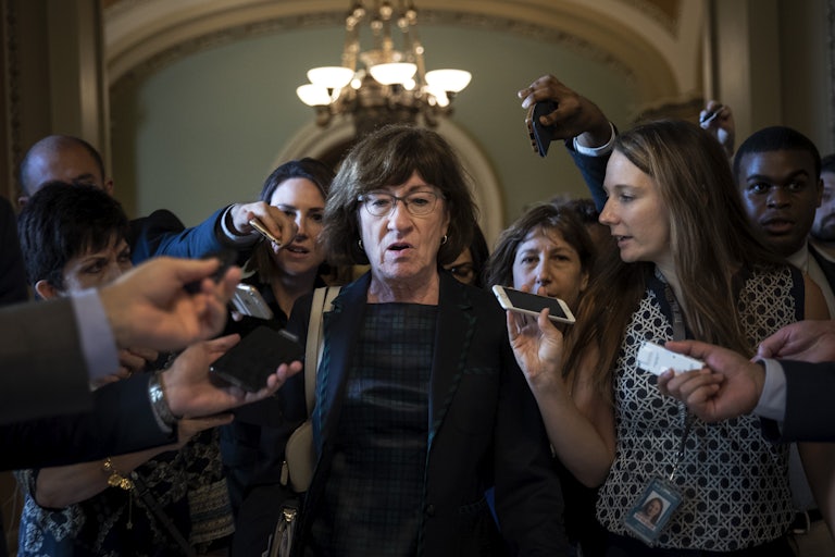 Sen. Susan Collins is surrounded by reporters following a closed-door meeting of Senate Republicans on Capitol Hill.