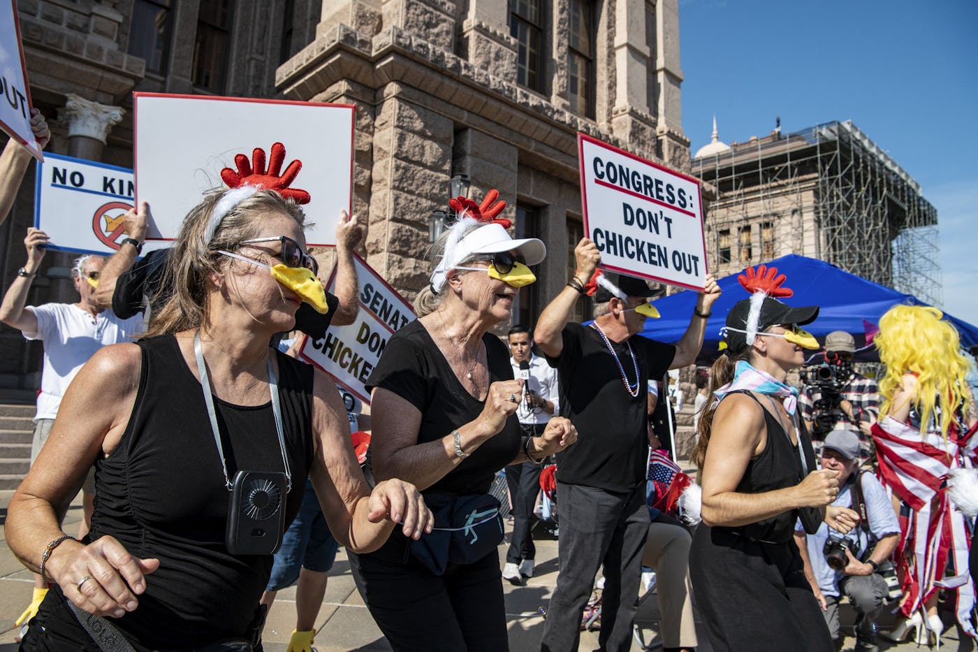 A group performs the "Chicken Dance" at the Texas State Capitol during a No Kings rally in Austin