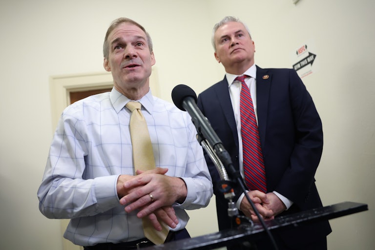Jim Jordan and James Comer standing in front of a mic