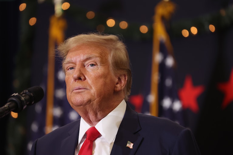 Republican presidential candidate and former U.S. President Donald Trump looks on during a campaign event in Waterloo, Iowa.