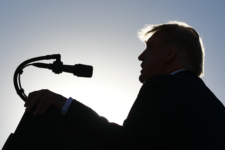 A silhouette of Donald Trump speaking at a campaign rally in Nevada