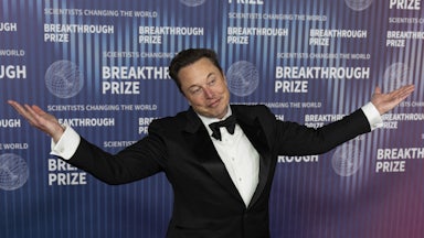 Elon Musks wears a tuxedo and shrugs.
