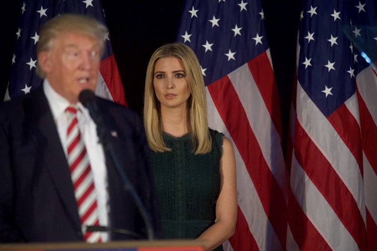 Ivanka Trump in the background looks at Donald Trump (blurred, foreground)