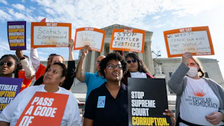 Demonstrators hold a press conference in front of the Supreme Court calling on Senate leadership to pass a binding code of ethics for Supreme Court justices.