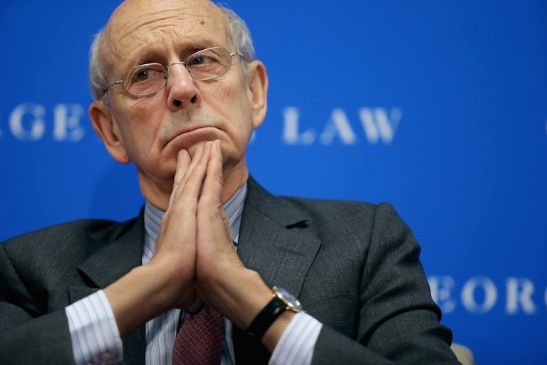 A close-up of Justice Stephen Breyer as he contemplates his next thoughts at a discussion.