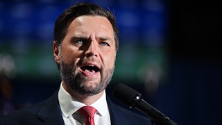 J.D. Vance speaks before a mic, brows furrowed