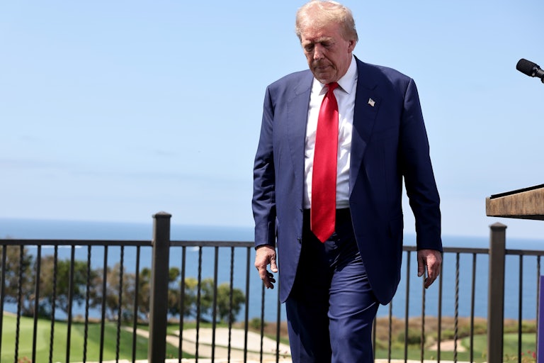 Donald Trump looks down as he walks away from a podium
