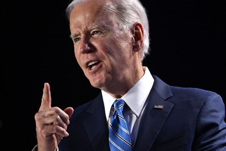 President Biden raises his index finger while speaking.