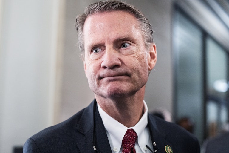 Representative Tim Burchett presses his lips together and stares off camera, eyes wide