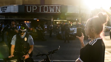 woman and Minneapolis Police officer at protest