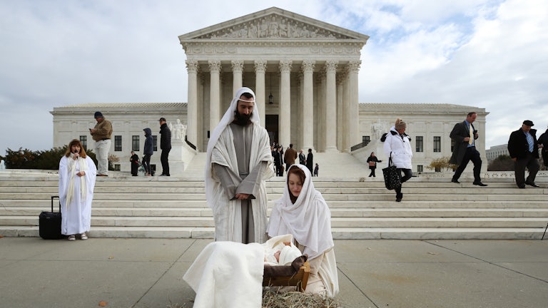 A couple portrays Mary and Joseph during a live nativity scene in front of the U.S. Supreme Court.