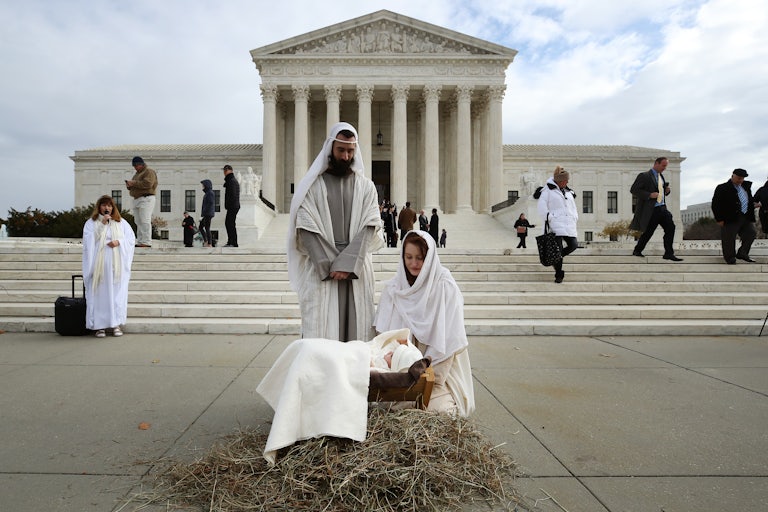 A couple portrays Mary and Joseph during a live nativity scene in front of the U.S. Supreme Court.