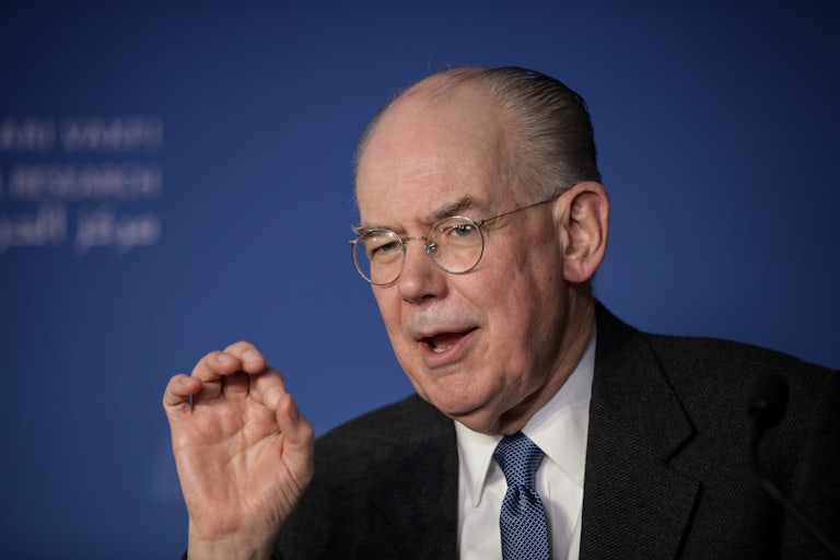 John Mearsheimer gesticulates while talking.