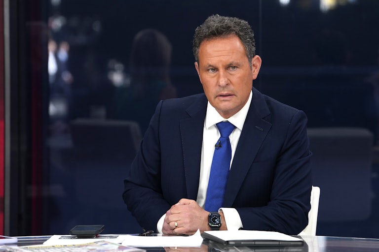 Fox News host Brian Kilmeade sits at a desk