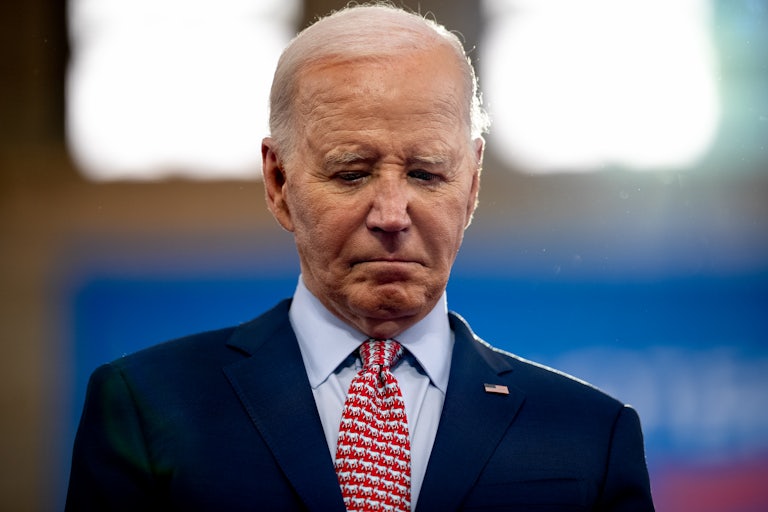 Joe Biden looks down, frowning