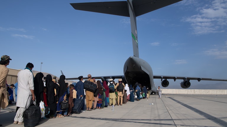 U.S. Air Force personnel load passengers aboard a U.S. Air Force C-17 Globemaster III in support of the Afghanistan evacuation in Kabul, Afghanistan in August of 2021. 