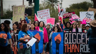 Demonstrators hold pro-choice signs.