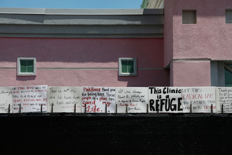 Posters outside the pink abortion clinic read things like "This clinic is a refuge" and "Pink House, thank you for being here. These people, this place, has saved my life." 