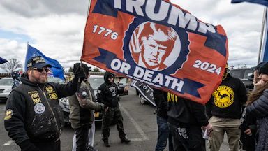 Proud Boys wave a Donald Trump flag