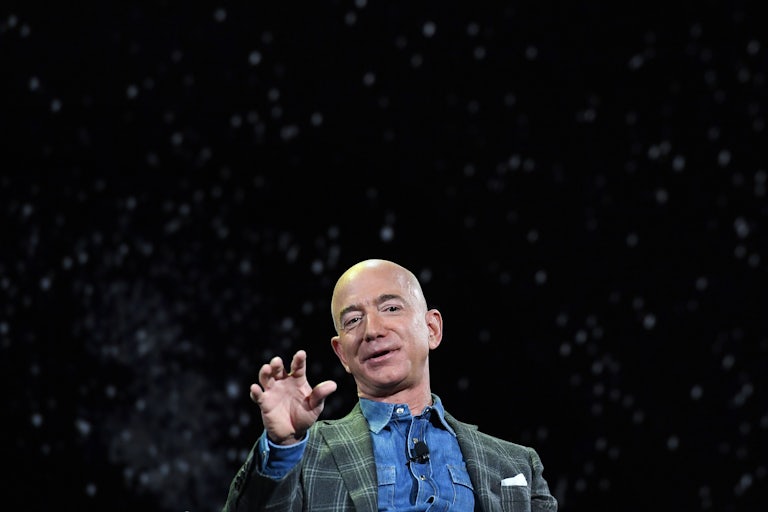 Jeff Bezos squints gestures while speaking to an audience 
