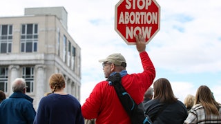 A protester holds a placard during the third annual Pennsylvania March for Life.