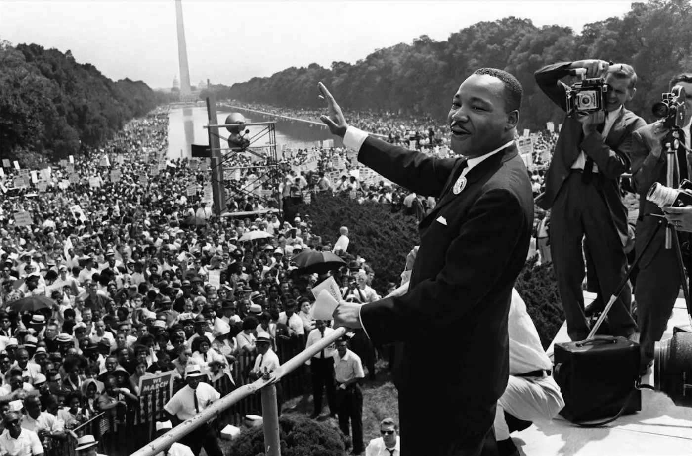 Dr. Martin Luther King Jr. waves to the massive crowd gathered at the National Mall during the March on Washington, August 28, 1963.
