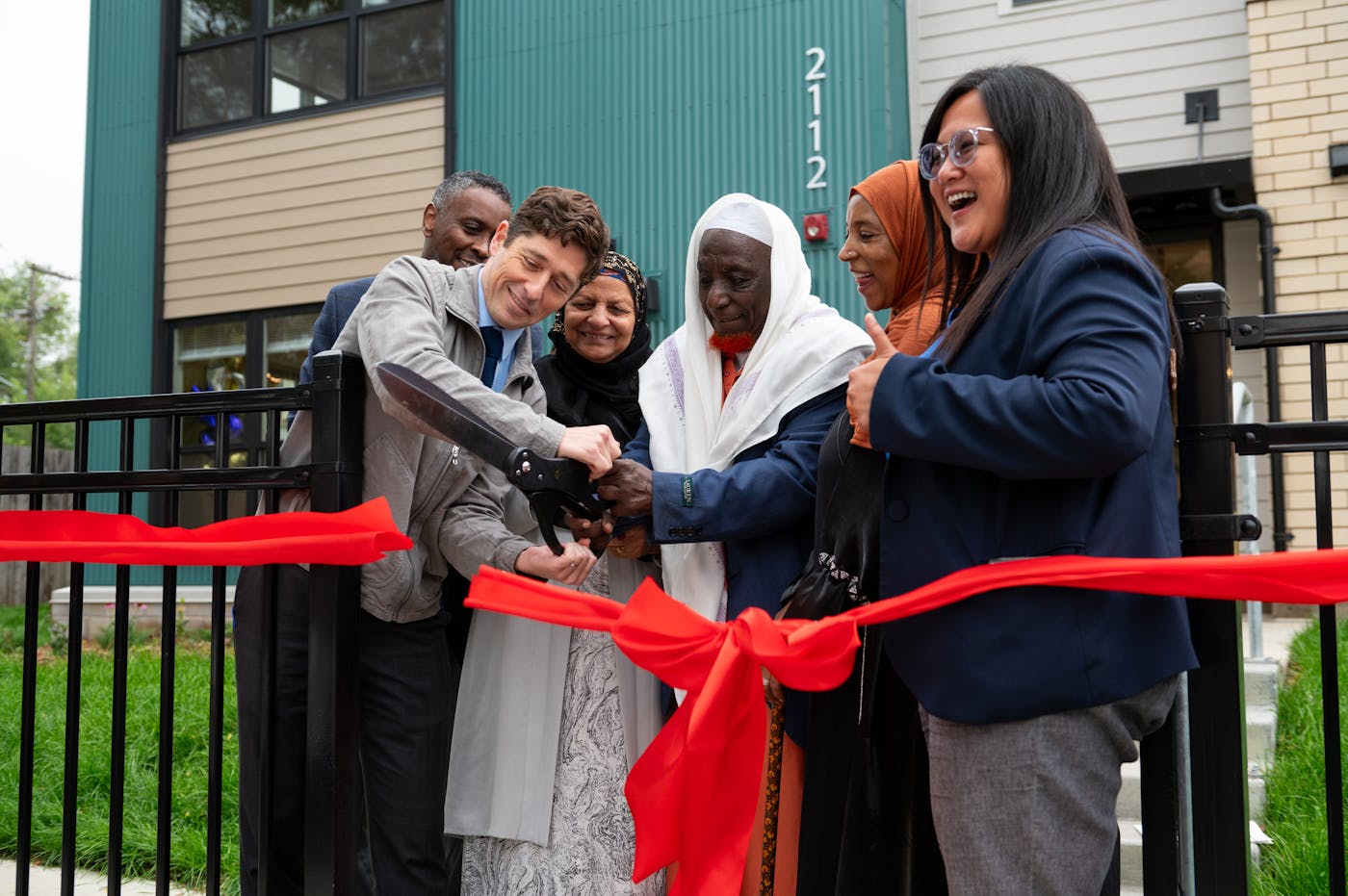 Minneapolis Mayor Jacob Frey and community leaders cut a ribbon at a new affordable housing complex in August.