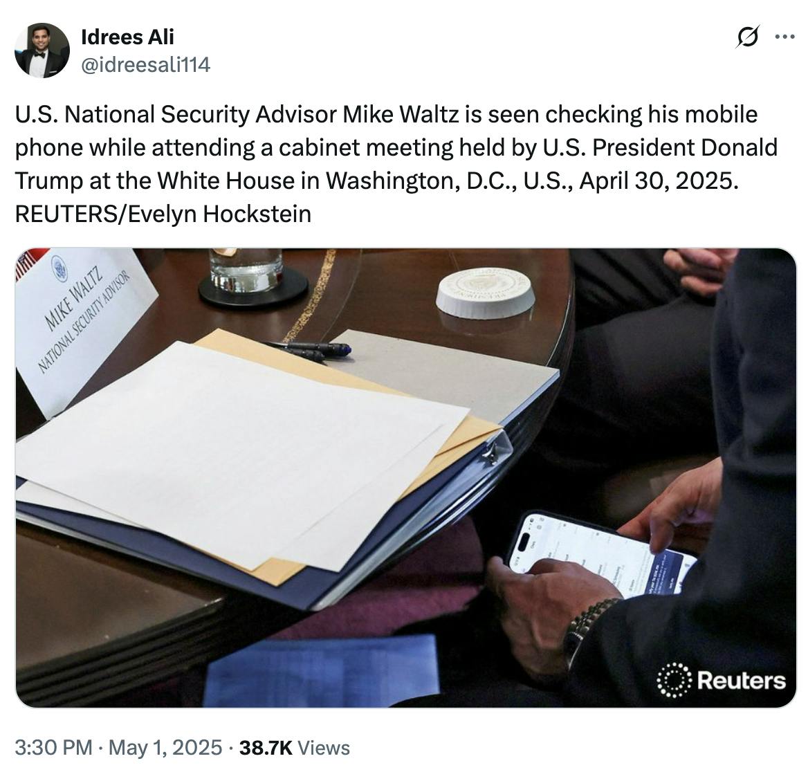 Charlie Spiering @charliespiering Photos show Mike Waltz literally checking Signal during the cabinet meeting (via Reuters) (another photo angle of Mike Waltz checking Signal under the table)