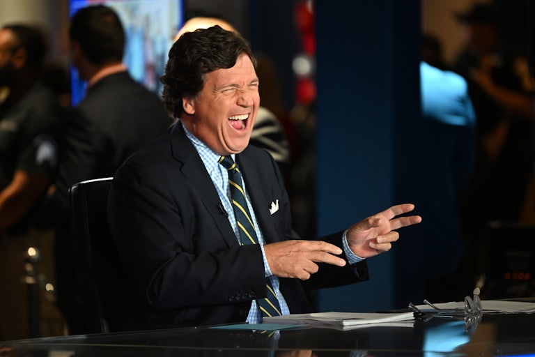 Tucker Carlson laughs