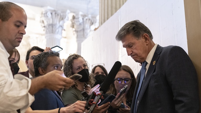 Joe Manchin talks to reporters during the “vote-a-rama” on the Inflation Reduction Act. 