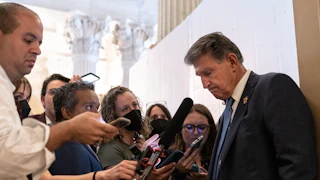 Joe Manchin talks to reporters during the “vote-a-rama” on the Inflation Reduction Act.