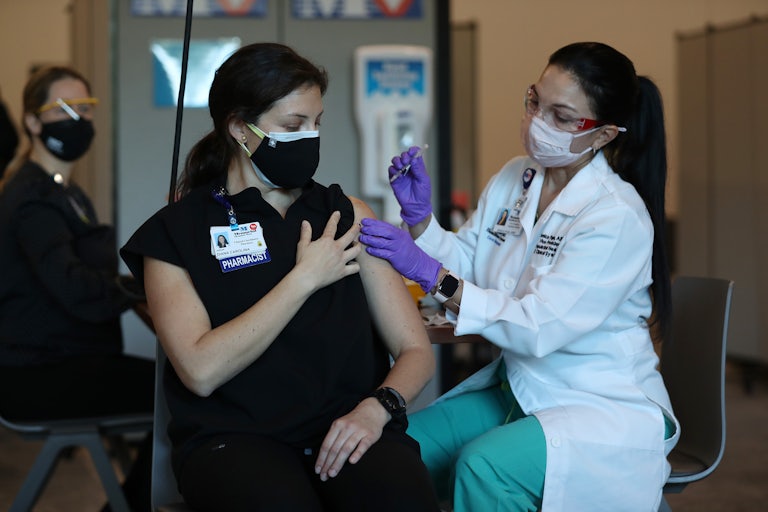 A woman in Florida is vaccinated in December 2020.