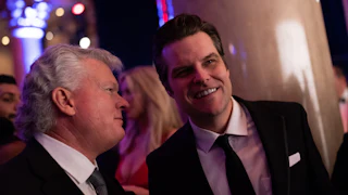 Matt Gaetz smiles while conversing with another person.