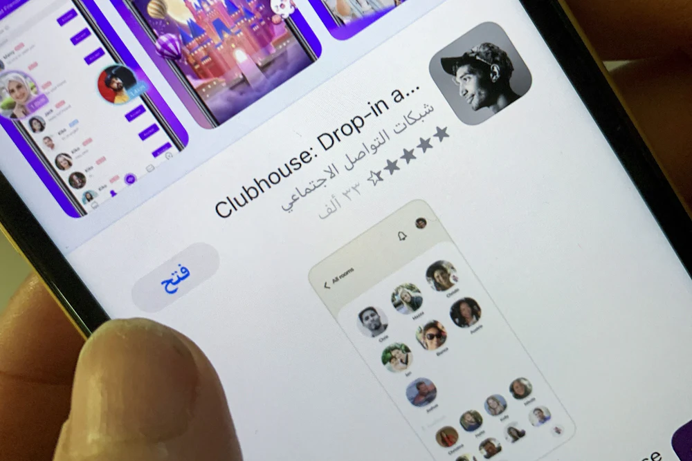 A woman checks the Clubhouse App on her phone in the Saudi capital of Riyadh.
