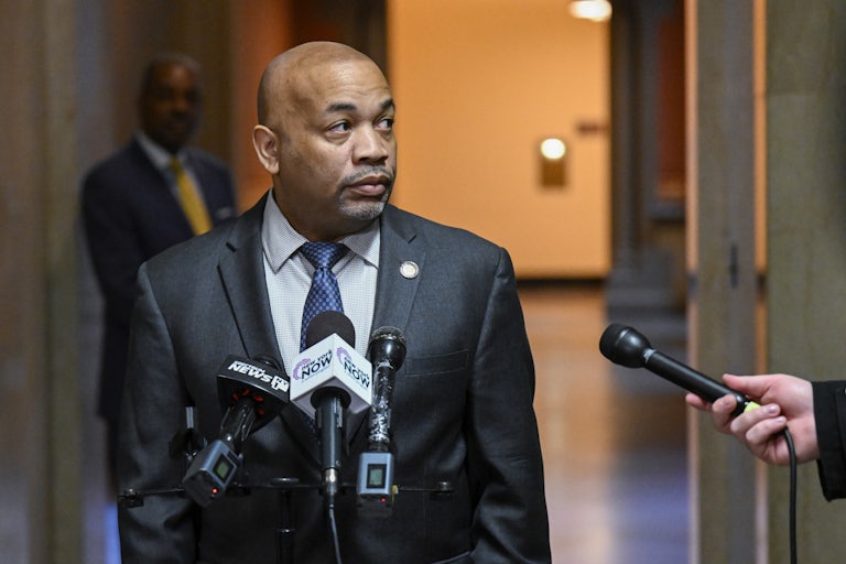 Carl Heastie speaks into microphones at a podium.